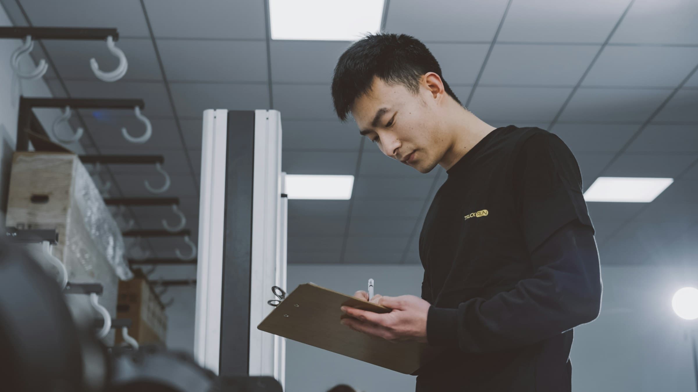 A quality inspector checking goods with a clipboard